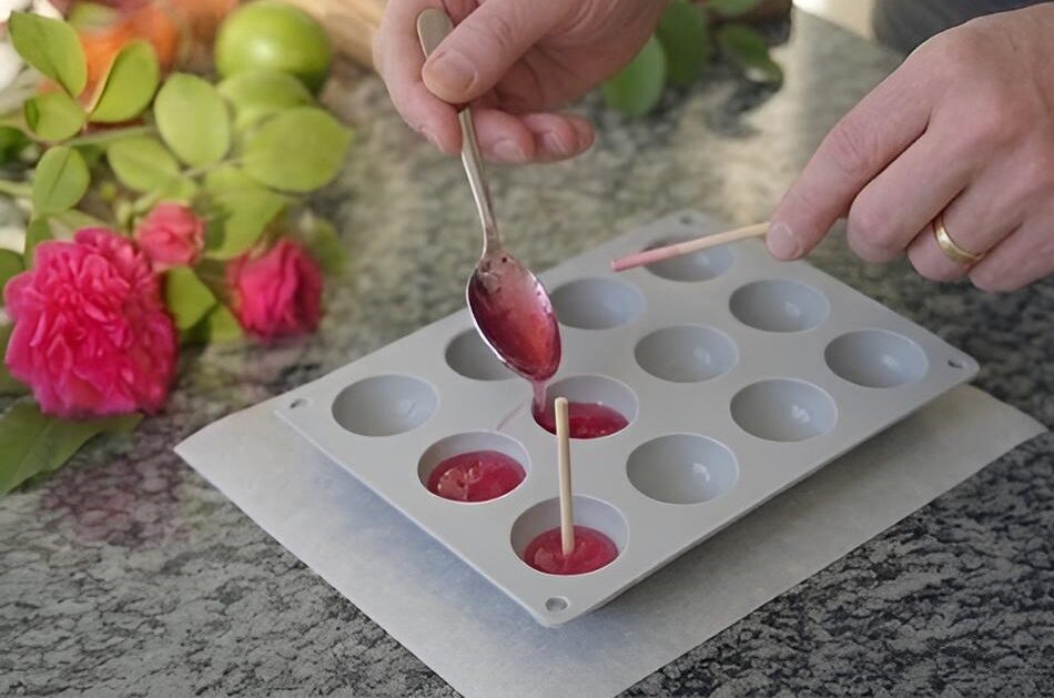 Mettre la préparation dans un moule  puis placer des bâtons de bois - Recette sucettes à la rose - ©Roses Guillot®
